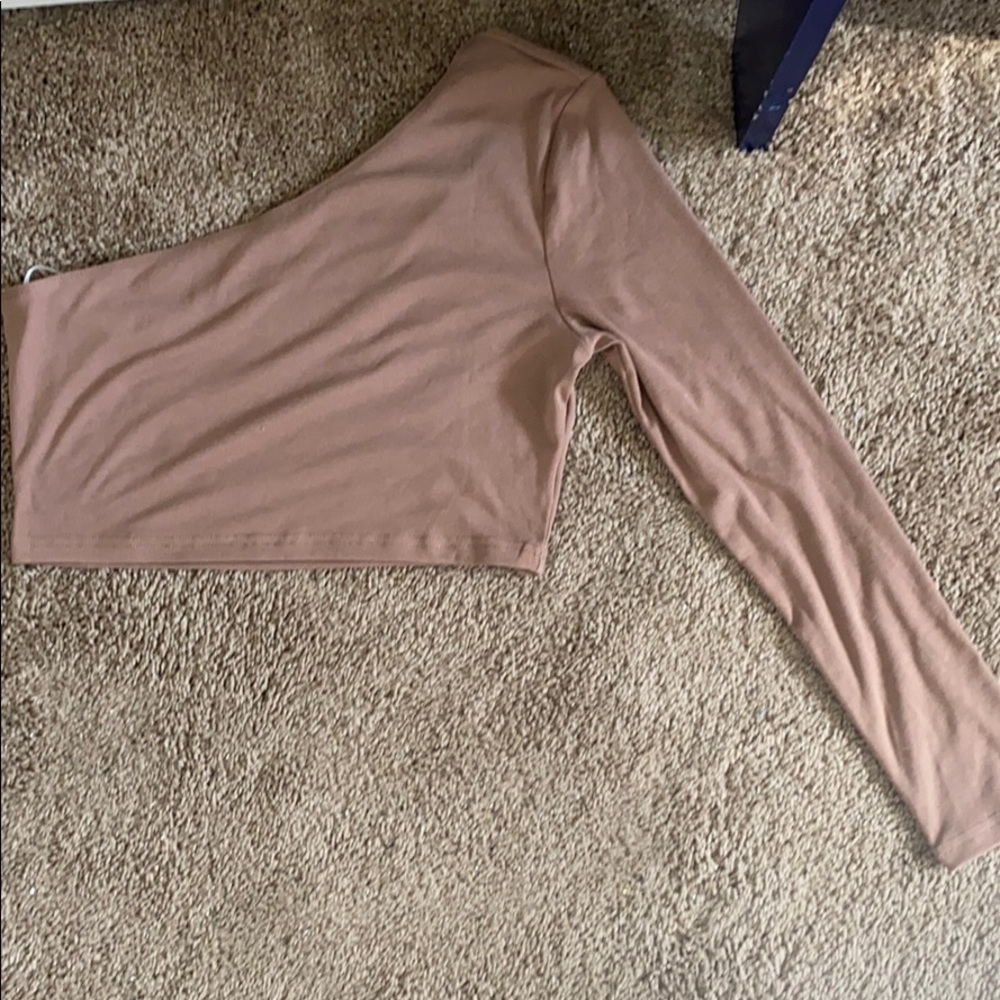 Long sleeve tan, half shoulder shirt.